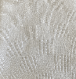 Closeup of white snag free blanket. Checkerboard pattern.