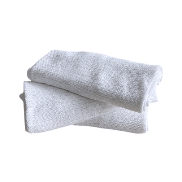 Stack of three open weave white blankets